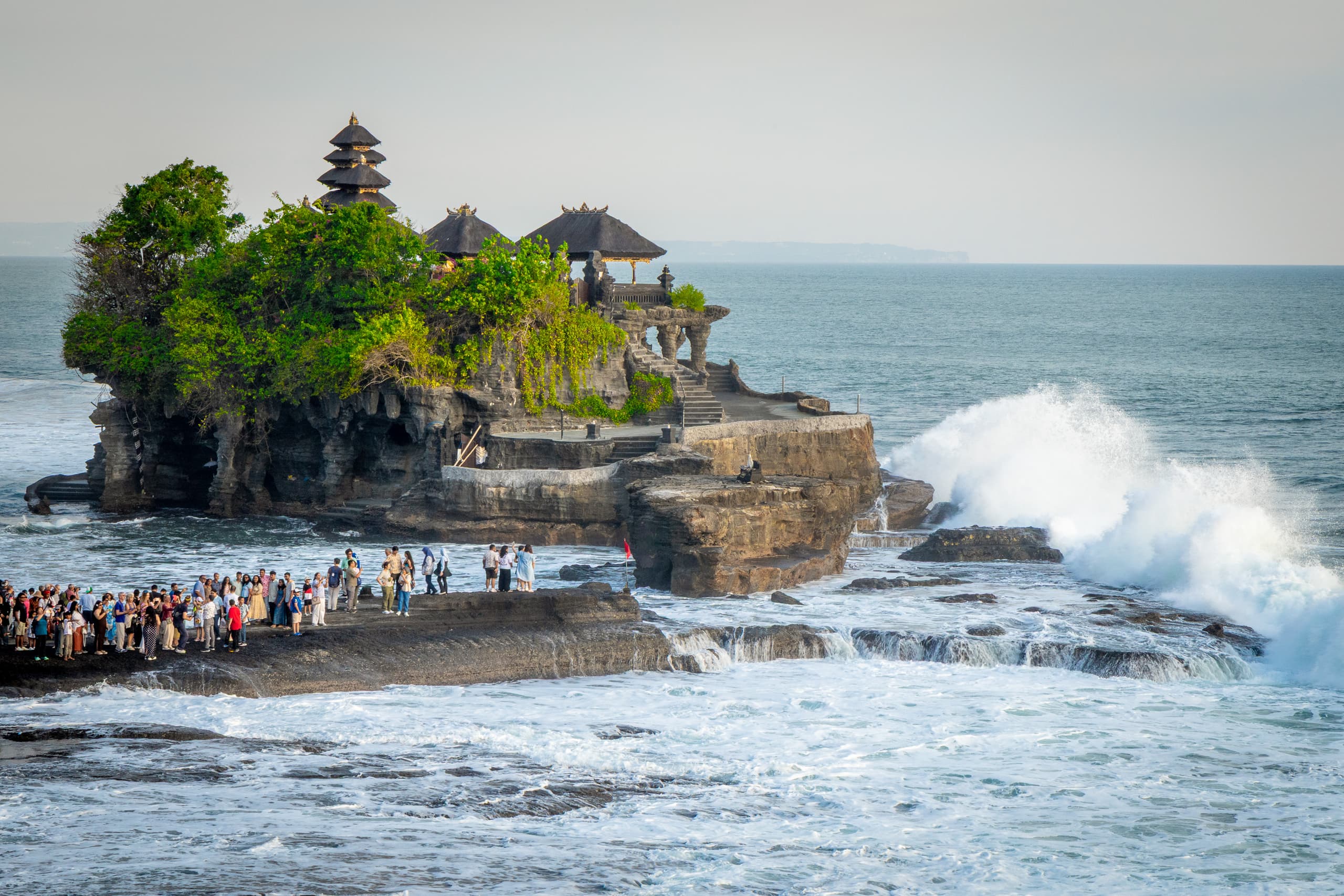 Pura Tanah Lot sea temple silhouetted against the sunset on a rocky outcrop off Bali’s west coast