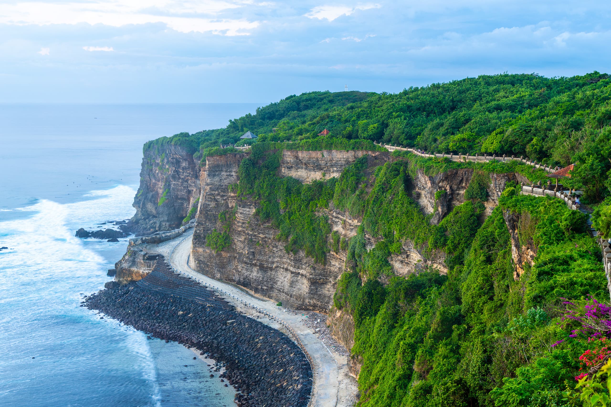 Pura Luhur Uluwatu sea temple perched on a limestone cliff above the Indian Ocean at sunset, Bali